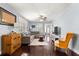 Bright living room featuring hardwood floors, a comfortable gray couch, and natural light from the windows at 1405 Ne 55Th St, Ocala, FL 34479