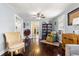Inviting living room with hardwood floors, natural light, and cozy reading nook featuring bookshelves at 1405 Ne 55Th St, Ocala, FL 34479