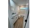 This bathroom offers granite countertops, white cabinets, modern fixtures, and a tub shower at 14437 Sw 21St Pl, Ocala, FL 34481