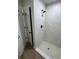 This bathroom features a stand up shower with white marble pattern tile and black shower hardware at 14437 Sw 21St Pl, Ocala, FL 34481