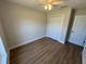A light and airy bedroom shows a closet, window, ceiling fan, and light wood look flooring at 14437 Sw 21St Pl, Ocala, FL 34481
