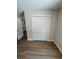 A bright bedroom offers a spacious closet and neutral walls and wood-look flooring at 14437 Sw 21St Pl, Ocala, FL 34481