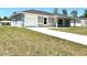 Charming single-story home featuring a well-maintained lawn and an attached one car garage at 14437 Sw 21St Pl, Ocala, FL 34481
