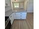 Kitchen island with granite countertops and white cabinets with modern hardware at 14437 Sw 21St Pl, Ocala, FL 34481