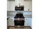 Modern kitchen with white cabinets, granite countertops and stainless steel appliances at 14437 Sw 21St Pl, Ocala, FL 34481