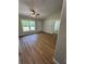 A light-filled living room features wood-look flooring and a view of the front door and front yard at 14437 Sw 21St Pl, Ocala, FL 34481