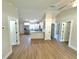 This living space showcases new flooring, white walls, and a view of the modern kitchen at 14437 Sw 21St Pl, Ocala, FL 34481