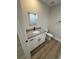 Modern bathroom features a white vanity cabinet, granite countertop, and matte black fixtures at 14443 Sw 21St Pl, Ocala, FL 34481
