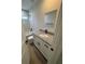 Updated bathroom with vanity, granite counters, matte black fixtures, and marble look shower at 14443 Sw 21St Pl, Ocala, FL 34481