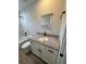 Bathroom boasting modern granite vanity, white cabinets, and a tub with shower in the background at 14443 Sw 21St Pl, Ocala, FL 34481