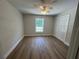 This bedroom features neutral paint, wood look floors and a ceiling fan with light at 14443 Sw 21St Pl, Ocala, FL 34481