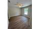 Empty bedroom featuring wood floors, a ceiling fan, and natural light from the window at 14443 Sw 21St Pl, Ocala, FL 34481