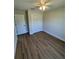 Bedroom features neutral paint, wood look floors, a ceiling fan and closet at 14443 Sw 21St Pl, Ocala, FL 34481