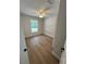 This bedroom features neutral paint, wood look floors, white trim and ceiling fan at 14443 Sw 21St Pl, Ocala, FL 34481