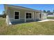 A charming front porch with decorative columns, windows, and a white front door at 14443 Sw 21St Pl, Ocala, FL 34481