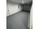 Spacious empty garage with gray painted floor and an automatic door at 14443 Sw 21St Pl, Ocala, FL 34481
