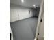 Empty garage with gray painted floor and a white door at 14443 Sw 21St Pl, Ocala, FL 34481