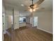 Bright and open living room featuring modern wood-look flooring, fan and view into the kitchen at 14443 Sw 21St Pl, Ocala, FL 34481