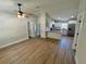 Open-concept living room with modern flooring, fan and views into kitchen with stainless steel appliances at 14443 Sw 21St Pl, Ocala, FL 34481