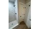 The elegant white tiled shower with a matte black shower head and hardware at 14443 Sw 21St Pl, Ocala, FL 34481