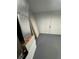 Unfinished storage room with gray painted floor and a white door at 14443 Sw 21St Pl, Ocala, FL 34481