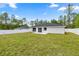 The backyard features a white fence, green grass and a patio for outdoor enjoyment at 15350 Sw 30Th Street, Ocala, FL 34481