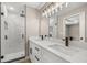 Bathroom featuring a double vanity with quartz countertops and a glass-enclosed shower with marble tiling at 15350 Sw 30Th Street, Ocala, FL 34481