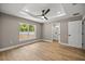 Bright bedroom features a ceiling fan, recessed lighting, and a large window overlooking the backyard at 15350 Sw 30Th Street, Ocala, FL 34481