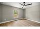 Bright and airy bedroom featuring a ceiling fan and large window offering a view of the outdoors at 15350 Sw 30Th Street, Ocala, FL 34481