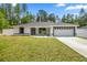 Charming single-story home featuring a freshly manicured lawn and a two-car garage at 15350 Sw 30Th Street, Ocala, FL 34481