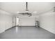 Spacious garage with epoxy floors, overhead lighting, and an automatic door at 15350 Sw 30Th Street, Ocala, FL 34481
