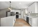 Bright, modern kitchen with white cabinets, center island, and stainless-steel appliances at 15350 Sw 30Th Street, Ocala, FL 34481