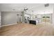Open-concept living area with new light wood floors and a modern kitchen island at 15350 Sw 30Th Street, Ocala, FL 34481