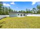 Spacious backyard with lush lawn, patio, and white privacy fence at 15368 Sw 30Th St, Ocala, FL 34481