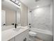 Bright bathroom featuring quartz countertops, a large mirror, and shower-tub combo at 15368 Sw 30Th St, Ocala, FL 34481
