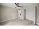 Bedroom with wood-look floors, a ceiling fan, and a closet at 15368 Sw 30Th St, Ocala, FL 34481