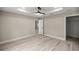 Bright bedroom with wood-look floors and neutral paint, features a walk-in closet at 15368 Sw 30Th St, Ocala, FL 34481