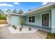 Inviting home exterior, featuring a light-blue facade, small palms, and fresh landscaping at 15368 Sw 30Th St, Ocala, FL 34481