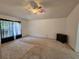 Large bedroom with a ceiling fan, curtains and a dresser, offering a comfortable space with a view to the outside at 18 Fir Trail Dr, Ocala, FL 34472