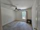 A cozy bedroom with a window, ceiling fan and natural light at 18 Fir Trail Dr, Ocala, FL 34472