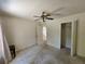 A spacious bedroom with a ceiling fan and an open closet provides ample storage at 18 Fir Trail Dr, Ocala, FL 34472
