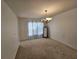 Simple dining room featuring a carpeted floor and hanging chandelier at 18 Fir Trail Dr, Ocala, FL 34472