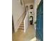 Bright foyer with staircase, featuring neutral tones and a view into the living spaces at 18 Fir Trail Dr, Ocala, FL 34472