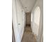 Hallway with closet space leading toward upstairs area, providing efficient storage and access to other areas of the home at 18 Fir Trail Dr, Ocala, FL 34472