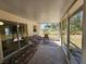 Enclosed patio with decorative rugs and outdoor seating offers a serene view of the property's surrounding landscape at 18 Fir Trail Dr, Ocala, FL 34472