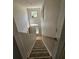 Interior view of staircase leading down to the entrance with arched windows at 18 Fir Trail Dr, Ocala, FL 34472