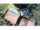 Aerial view featuring a pool, tennis court, and community building with parking at 2008 Tweed Ct, Leesburg, FL 34788