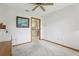 Bedroom with neutral carpet, ceiling fan, and doorway to another room at 2008 Tweed Ct, Leesburg, FL 34788