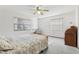 Bright bedroom featuring a ceiling fan and natural light through large windows at 2008 Tweed Ct, Leesburg, FL 34788