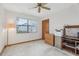 Bedroom with neutral carpet, a ceiling fan, large window and closet at 2008 Tweed Ct, Leesburg, FL 34788